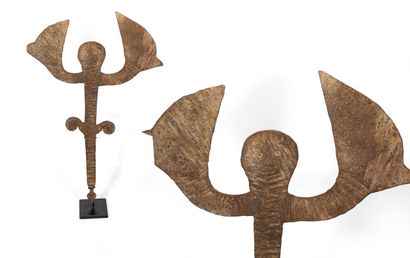 Idoma coin in beaten and oxidized iron forming...