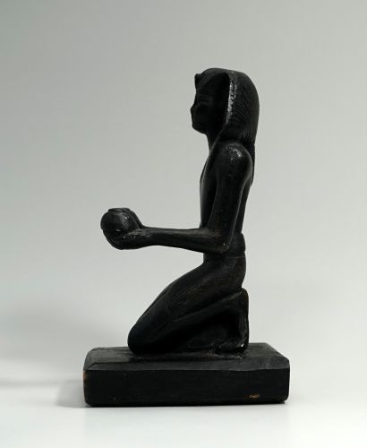 Museum cast: Thutmose kneeling with two libation...