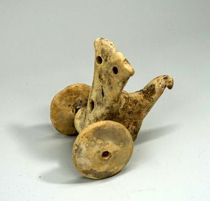 Statuette representing a stylized chariot....