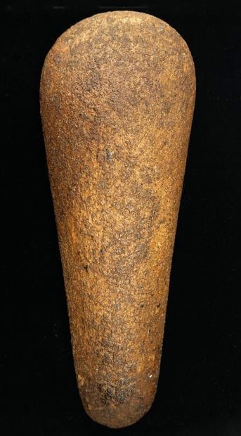Important polished axe in brown/caramel sandstone,...