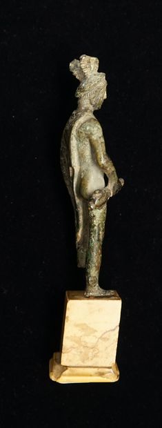Mercury standing on a marble base. He is...