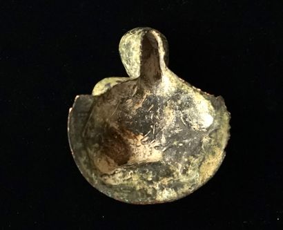 Medallion representing a chubby child holding...