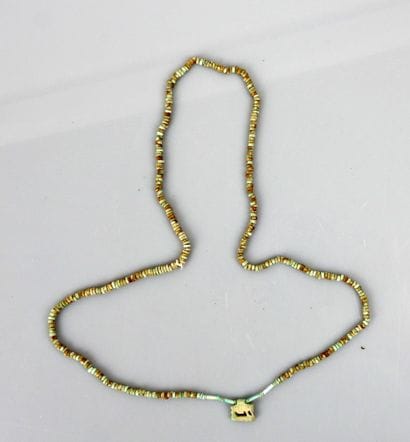 Mummiform necklace with an amulet representing...