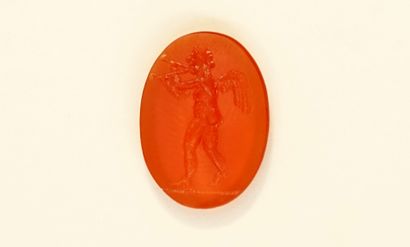 Intaglio showing a winged aulete. Carnelian....
