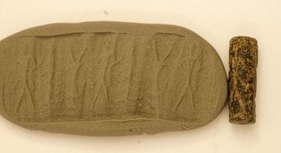 Cylinder seal presenting characters walking,...