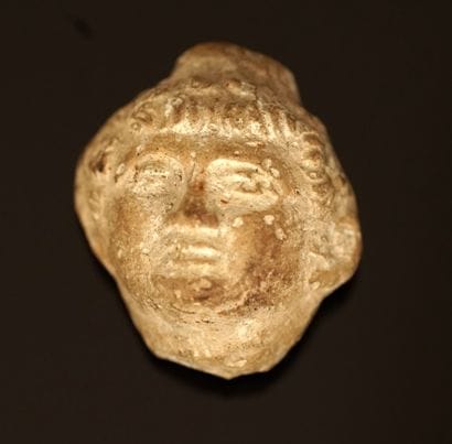 Small head representing a young man in limestone....
