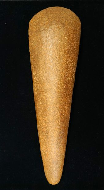 Important polished axe made of caramel beige...