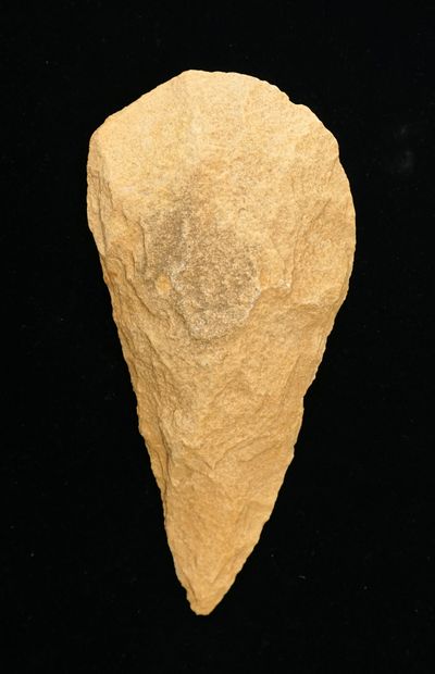 Almond-shaped biface in light beige quartzite....
