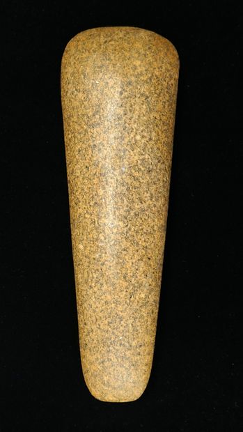 Polished axe in beige speckled stone. Possibly...
