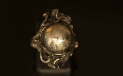 Silver ring with a floral design centered...