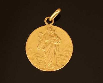 Religious medal in yellow gold 18k (750/°°)....