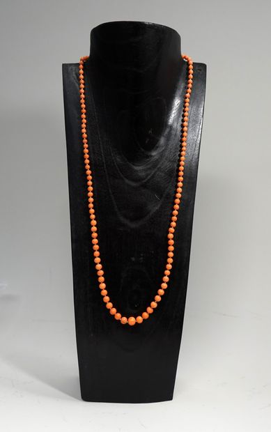 SAUTOIR of round coral beads in fall from...