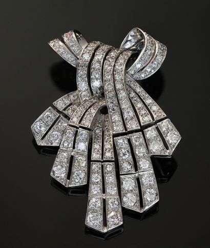 A platinum clip presenting a knotted ribbon...