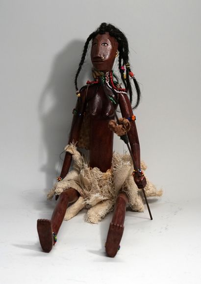Female puppet carrying spear and basket....