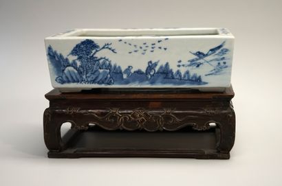 White and blue porcelain planter decorated...