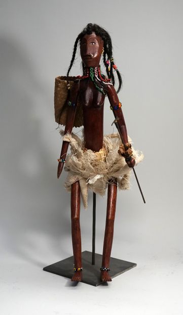 Female puppet carrying spear and basket....