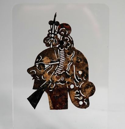 Old shadow puppet head, cut animal skin,...