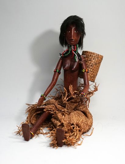 Female puppet from the village carrying a...