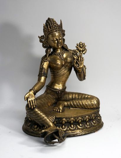 Green tara in patinated brass sitting in...