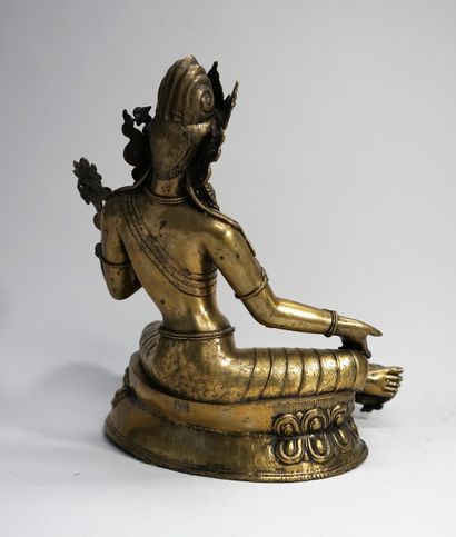 Green tara in patinated brass sitting in...