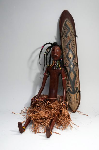 Male puppet carrying shield and basket. He...