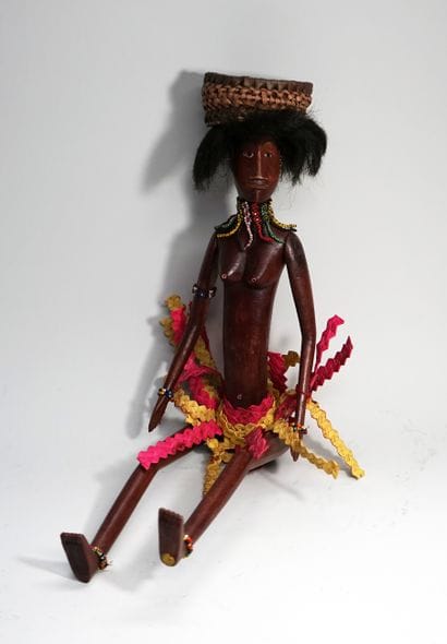 Female puppet from the village, carrying...