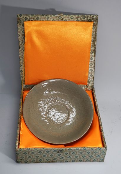 Round hollow dish with celadon glaze. Defect...