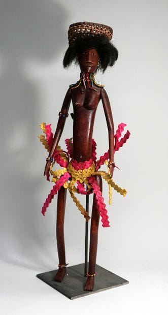 Female puppet from the village, carrying...