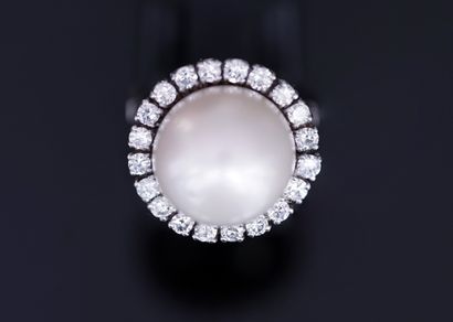 Platinum ring centered on a large white cultured...