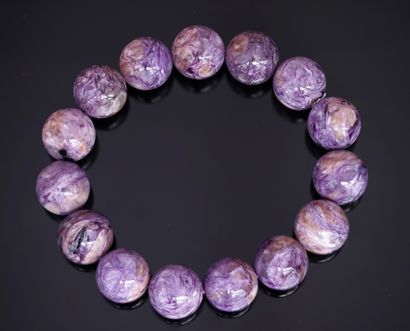 BRACELET of round charoite beads of 14mm....