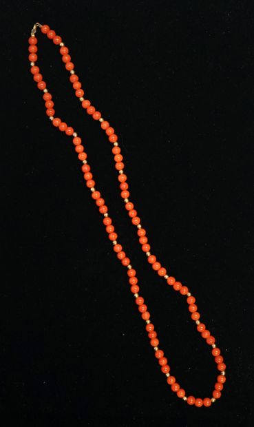 NECKLACE composed of round red coral beads...