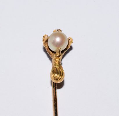 SET of three 18K (750°) gold pins, one with...