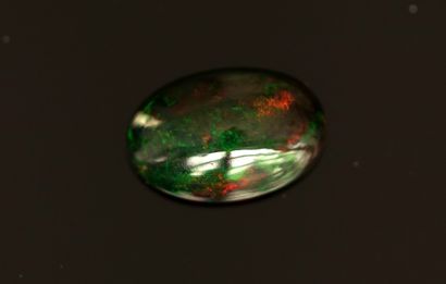 BLACK OPAL on paper, 6.40ct, oval cabochon....