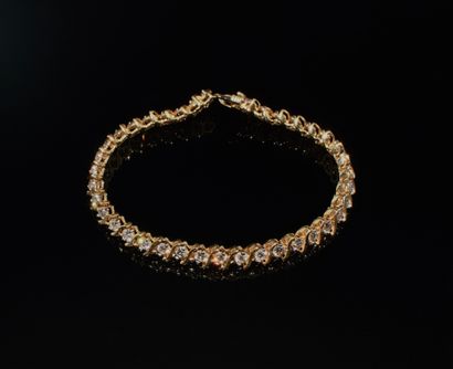 BRACELET in 14K (585°°) yellow gold rivière...
