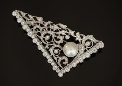 Silver-plated brooch featuring an openwork...