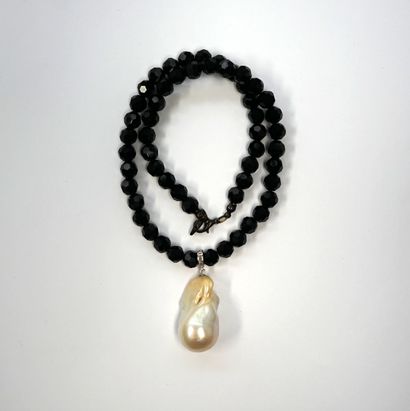 COLLAR of faceted black glass beads holding...