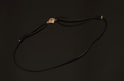 BRACELET on adjustable cord holding a small...