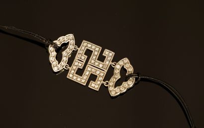 BRACELET on cord holding a rhodium-plated...