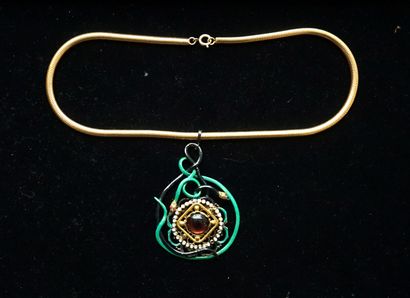 Gilded metal snake chain holding a large...