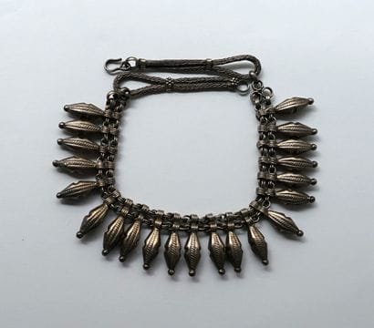 Silver-plated collar necklace adorned with...