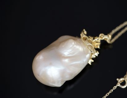 silver necklace holding a large baroque cultured...