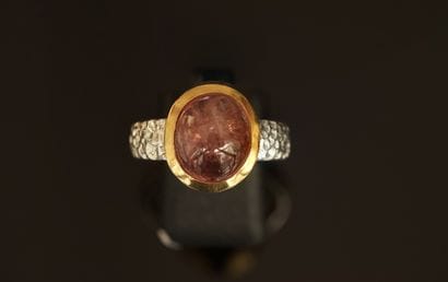 Silver and silver-gilt ring centered on an...