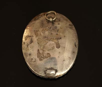 Oval silver and metal pendant centered on...