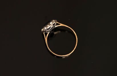 Gold and silver ring centered on a rectangular...