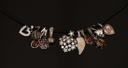 11 silver charms, some with mother-of-pearl,...