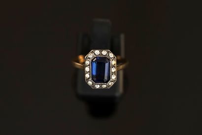 Gold and silver ring centered on a rectangular...