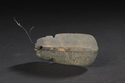 Ceremonial axe-shaped pendant engraved with...
