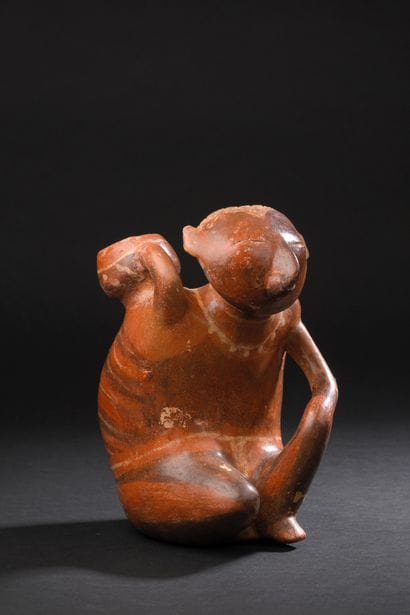 Anthropomorphic vase depicting a seated
offering...