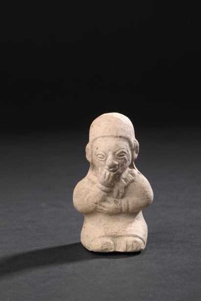 Ceremonial whistle depicting a seated person-
seated,...