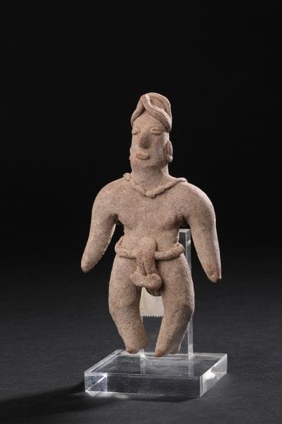 Standing figure wearing a loincloth and adorned
with...